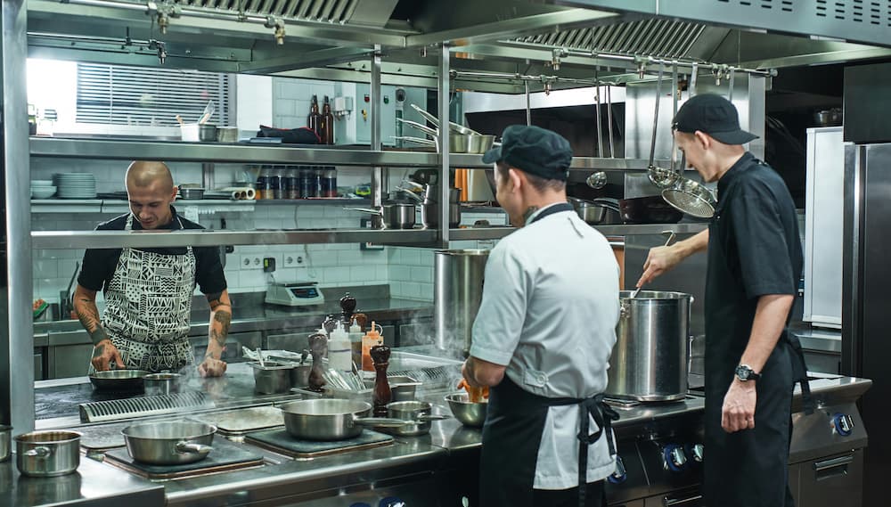 profissionais trabalhando em cozinha de restaurante