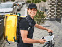 entregador de delivery sorridente de bicicleta